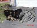 thumbnail of house with sinkhole in driveway